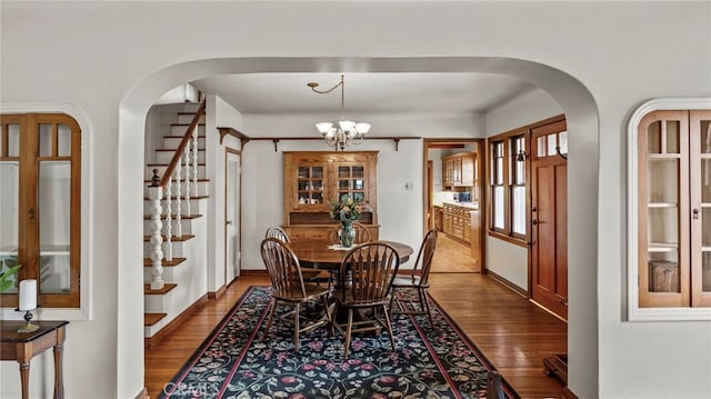 dining room with hardwood / wood-style flooring and a chandelier