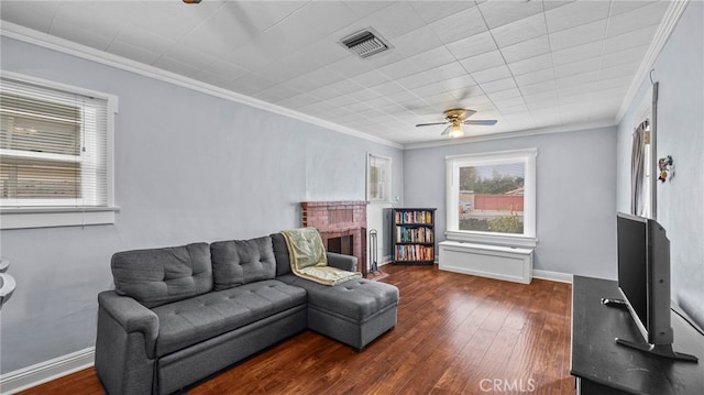 living room with a fireplace, ornamental molding, dark hardwood / wood-style floors, and ceiling fan