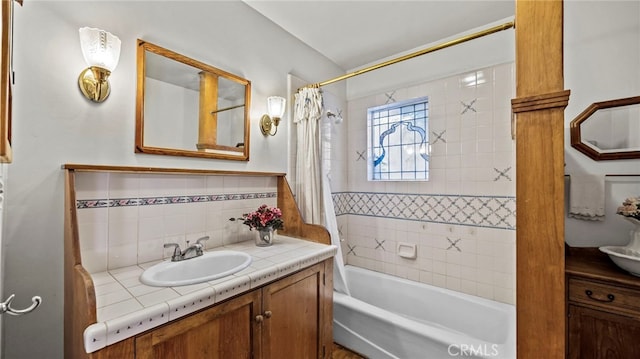 bathroom with shower / tub combo, backsplash, and vanity