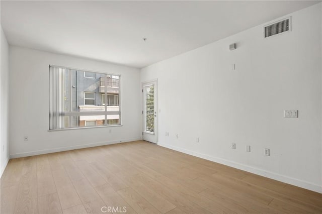 spare room featuring light hardwood / wood-style floors