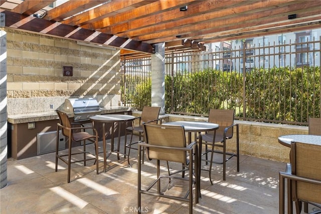 view of patio / terrace featuring exterior kitchen, area for grilling, and a pergola