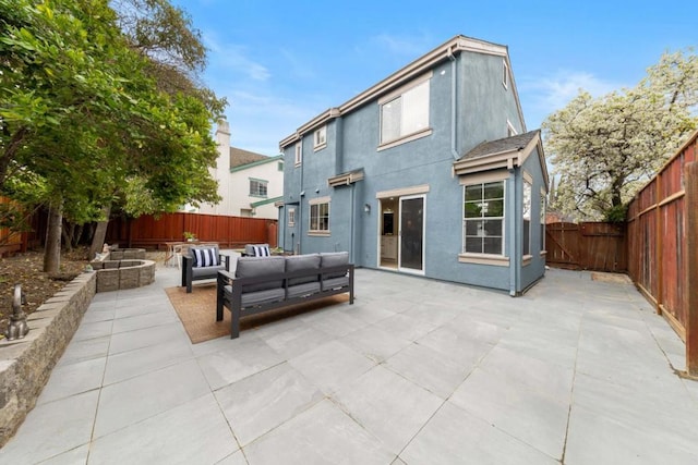 rear view of house featuring a patio and outdoor lounge area