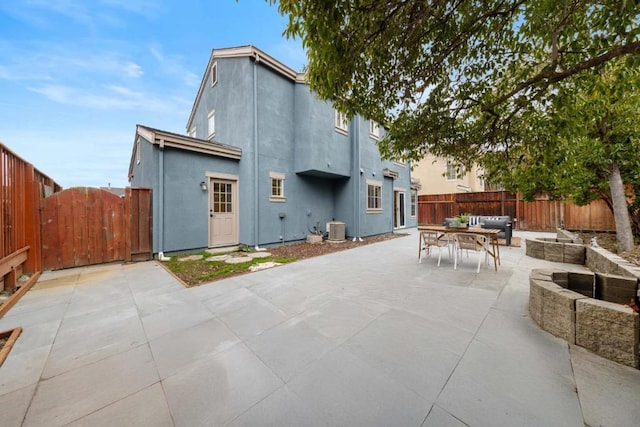 back of house with cooling unit, an outdoor living space, and a patio