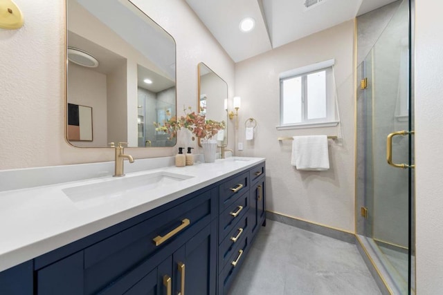 bathroom with vanity and a shower with shower door