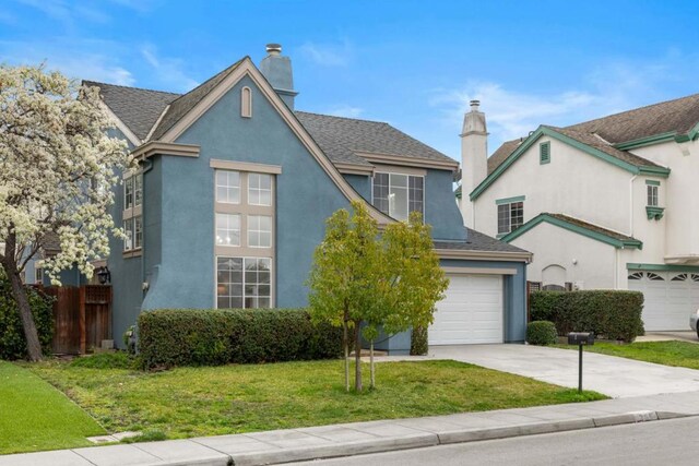 view of front of property featuring a garage and a front lawn