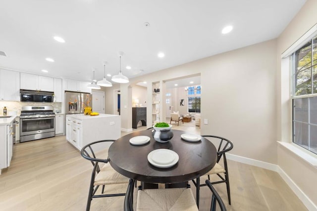 dining area with light hardwood / wood-style floors