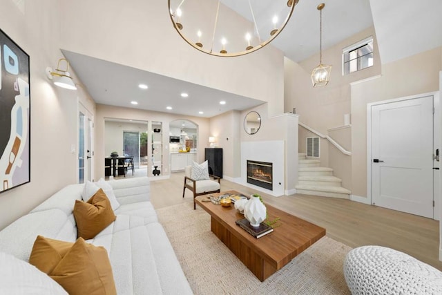 living room featuring a high ceiling and light wood-type flooring