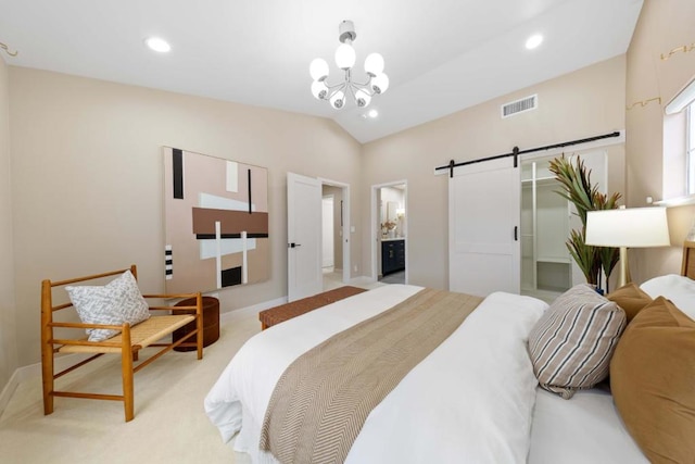 carpeted bedroom featuring a barn door, lofted ceiling, a chandelier, and ensuite bath