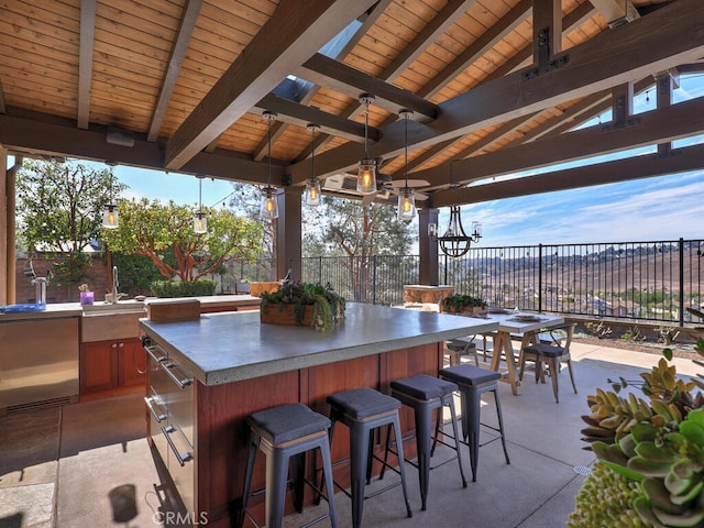 view of patio / terrace featuring a gazebo, ceiling fan, and an outdoor wet bar