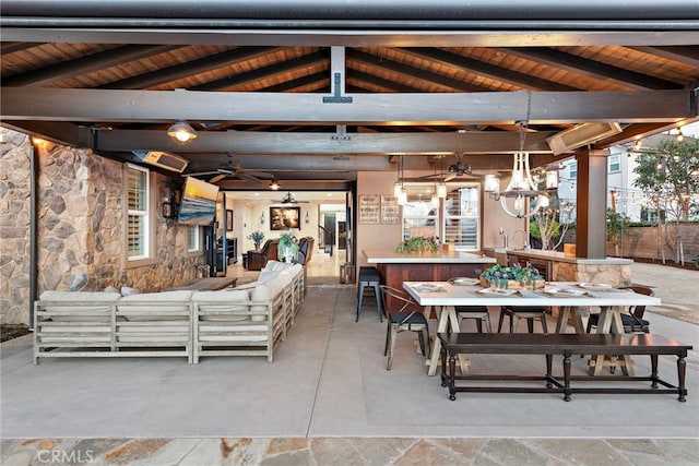 view of patio featuring a gazebo, exterior bar, an outdoor hangout area, and ceiling fan