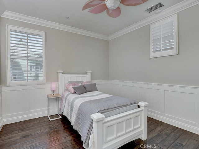 bedroom with ceiling fan, ornamental molding, and dark hardwood / wood-style flooring