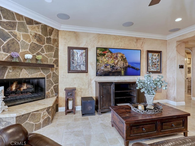 living room with ornamental molding and a fireplace