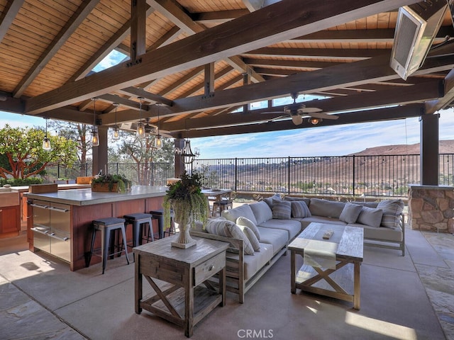 view of patio featuring a gazebo, outdoor lounge area, an outdoor bar, and ceiling fan