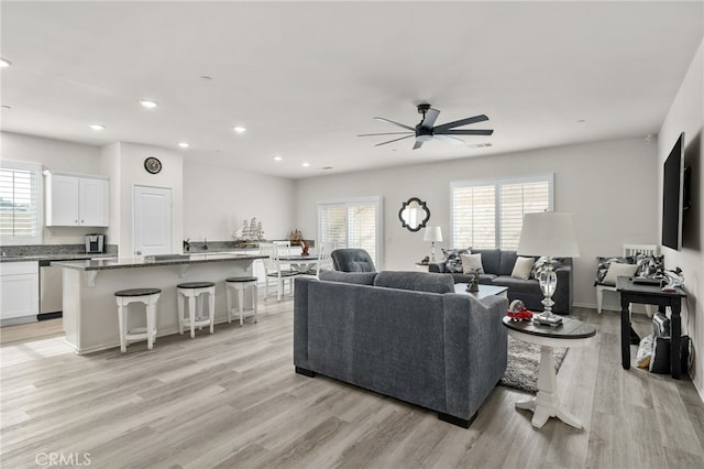 living area featuring plenty of natural light, recessed lighting, light wood-type flooring, and ceiling fan