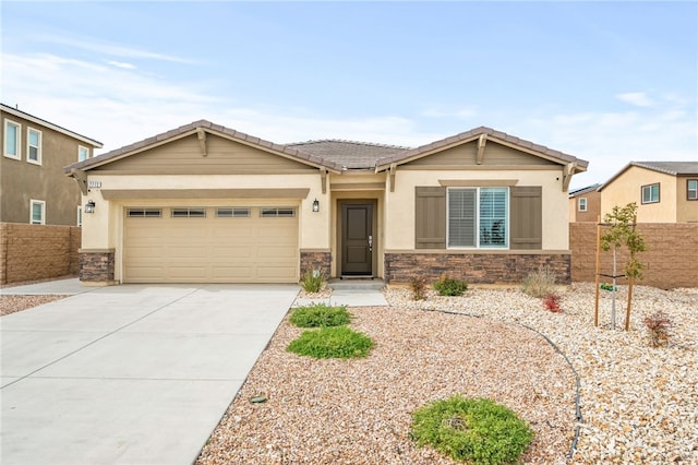 view of front of home with a garage, stone siding, driveway, and fence