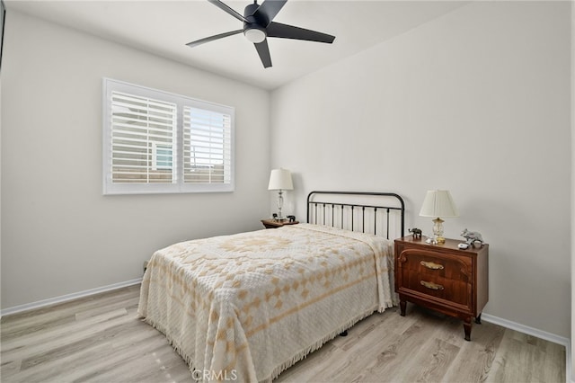 bedroom with wood finished floors, baseboards, and ceiling fan