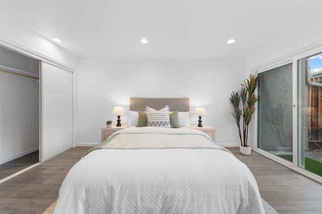 bedroom featuring dark hardwood / wood-style floors, access to outside, and a closet