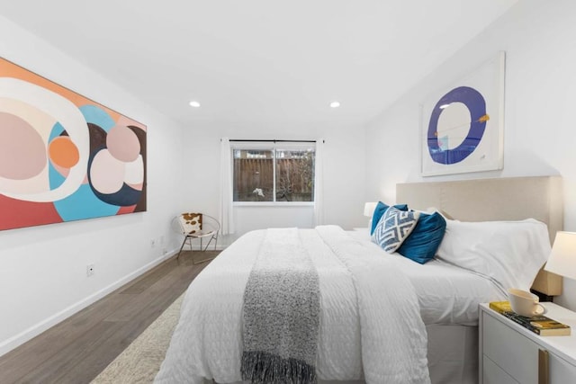 bedroom with dark hardwood / wood-style flooring