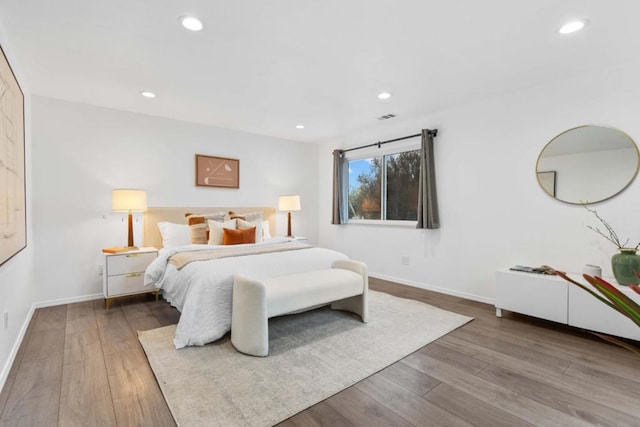 bedroom with hardwood / wood-style floors