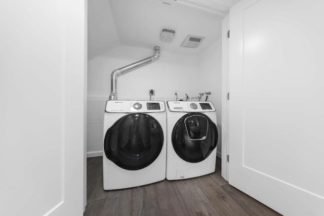 laundry room with dark hardwood / wood-style flooring and washer and dryer