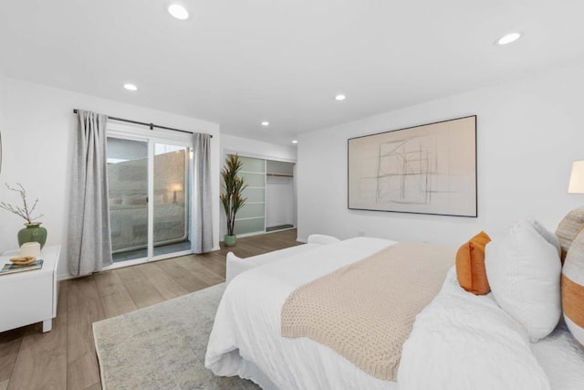 bedroom with wood-type flooring and a closet