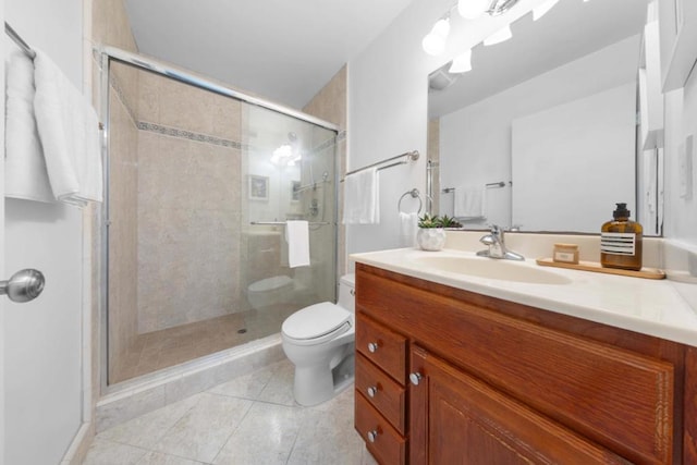 bathroom with walk in shower, tile patterned floors, vanity, and toilet