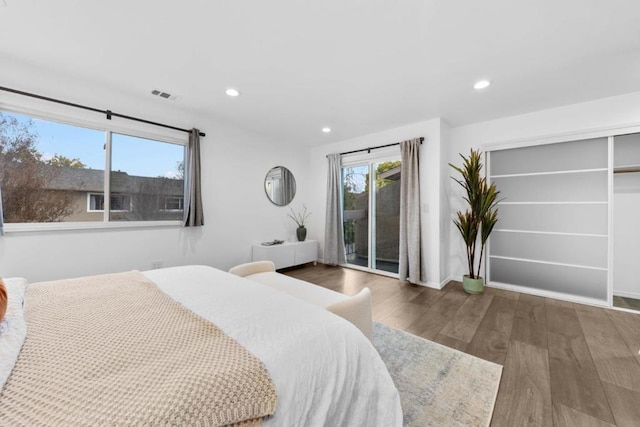 bedroom with dark wood-type flooring and access to exterior