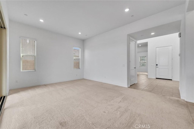 spare room with light colored carpet