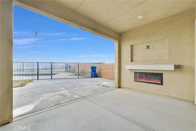 view of patio with a water view and a fenced in pool