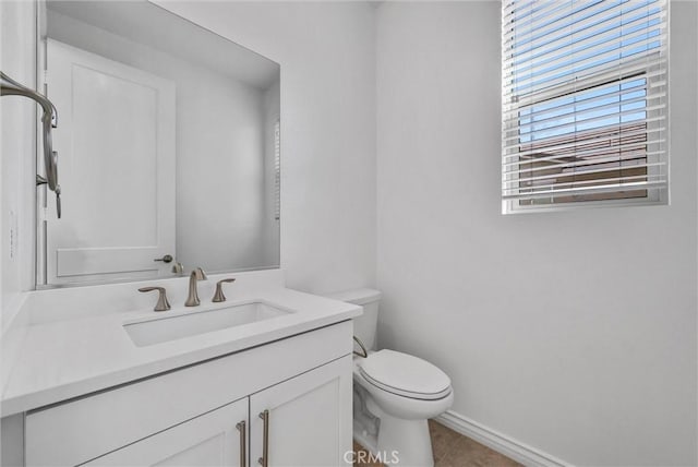 bathroom featuring vanity, tile patterned flooring, and toilet