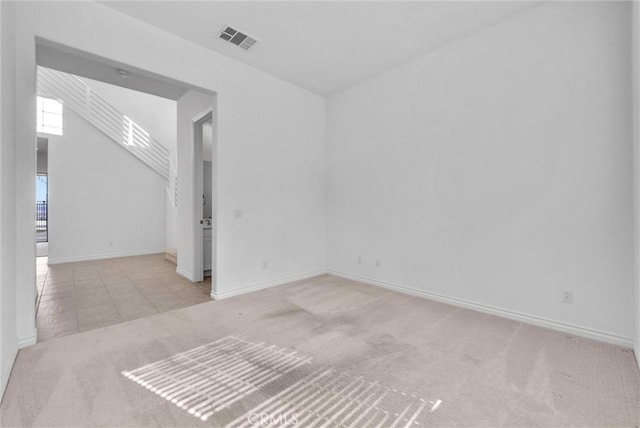 unfurnished room with light carpet