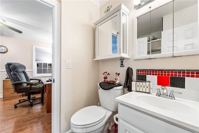 bathroom with vanity, toilet, and hardwood / wood-style floors