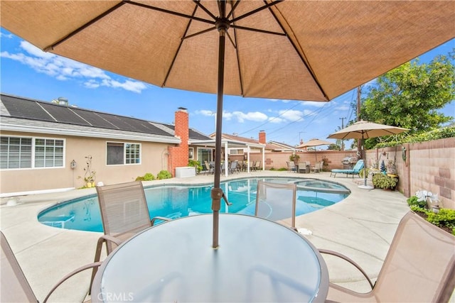 view of pool with a patio and an in ground hot tub