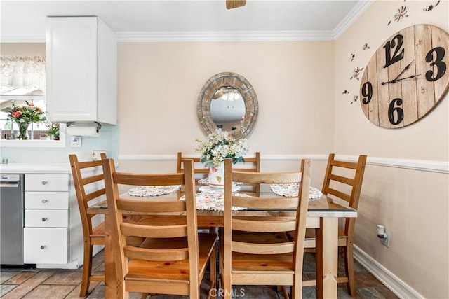 dining room featuring crown molding