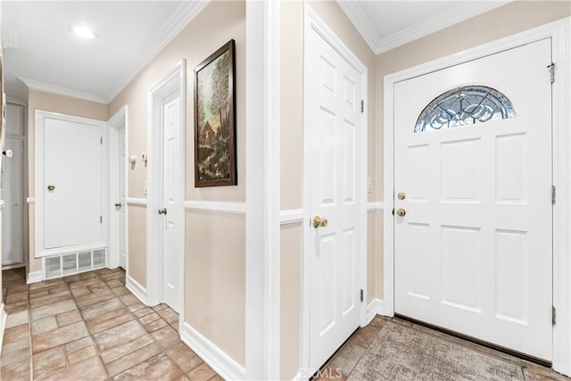 foyer featuring ornamental molding