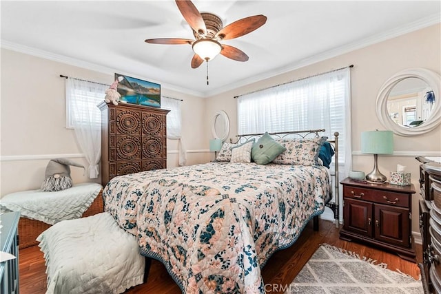 bedroom featuring dark hardwood / wood-style flooring, ornamental molding, and ceiling fan