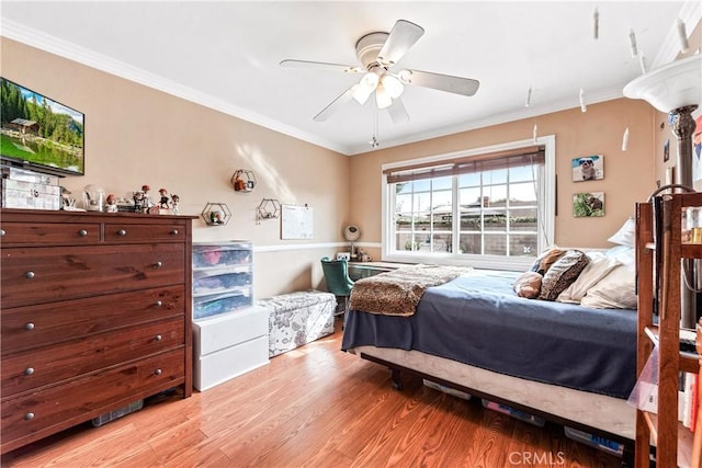 bedroom with ornamental molding, light hardwood / wood-style flooring, and ceiling fan