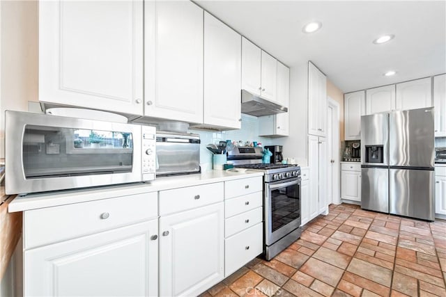 kitchen featuring appliances with stainless steel finishes, white cabinets, and tasteful backsplash