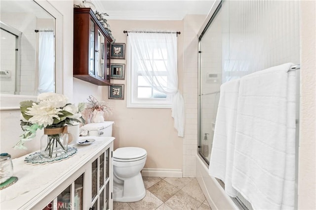 bathroom with toilet, tile patterned flooring, crown molding, and enclosed tub / shower combo