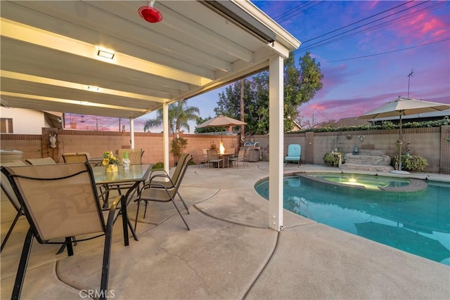 pool at dusk with a patio