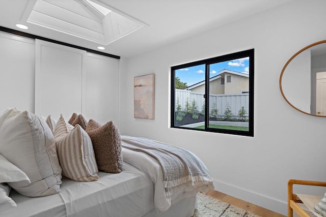 bedroom featuring hardwood / wood-style floors and a closet