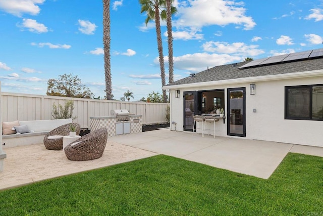 view of yard with exterior kitchen and a patio