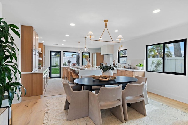 dining area featuring an inviting chandelier and light hardwood / wood-style floors