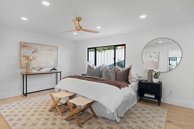 bedroom with ceiling fan and light hardwood / wood-style floors