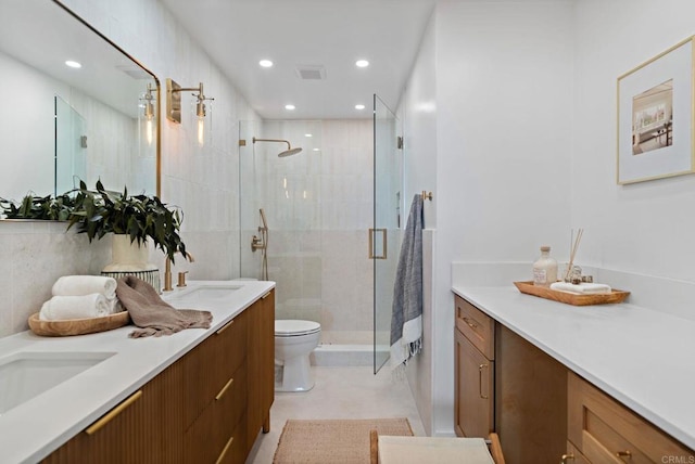 bathroom with vanity, toilet, and a shower with shower door