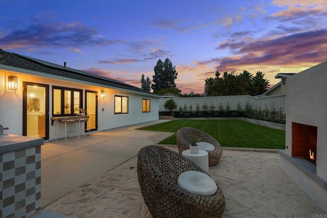 patio terrace at dusk with a lawn