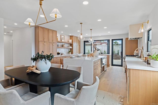 dining room featuring sink and light hardwood / wood-style floors