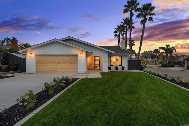 ranch-style home with a garage and a lawn