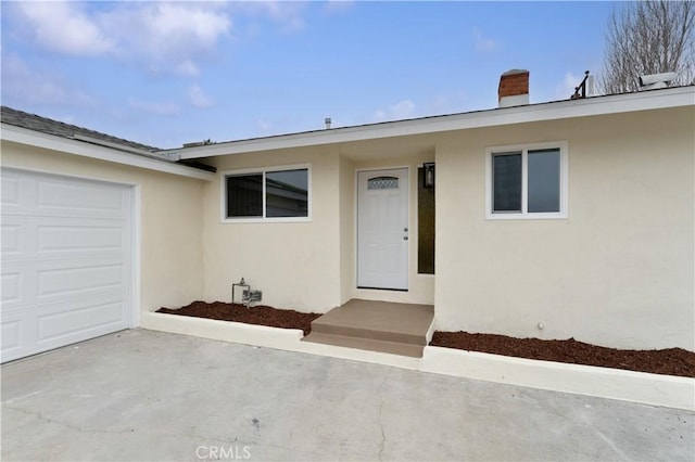 doorway to property featuring a garage