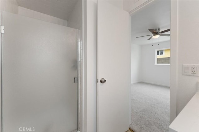 bathroom featuring an enclosed shower and ceiling fan